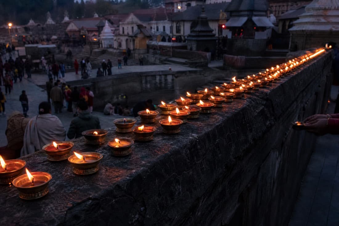 Rows of oil lamps lit at dusk