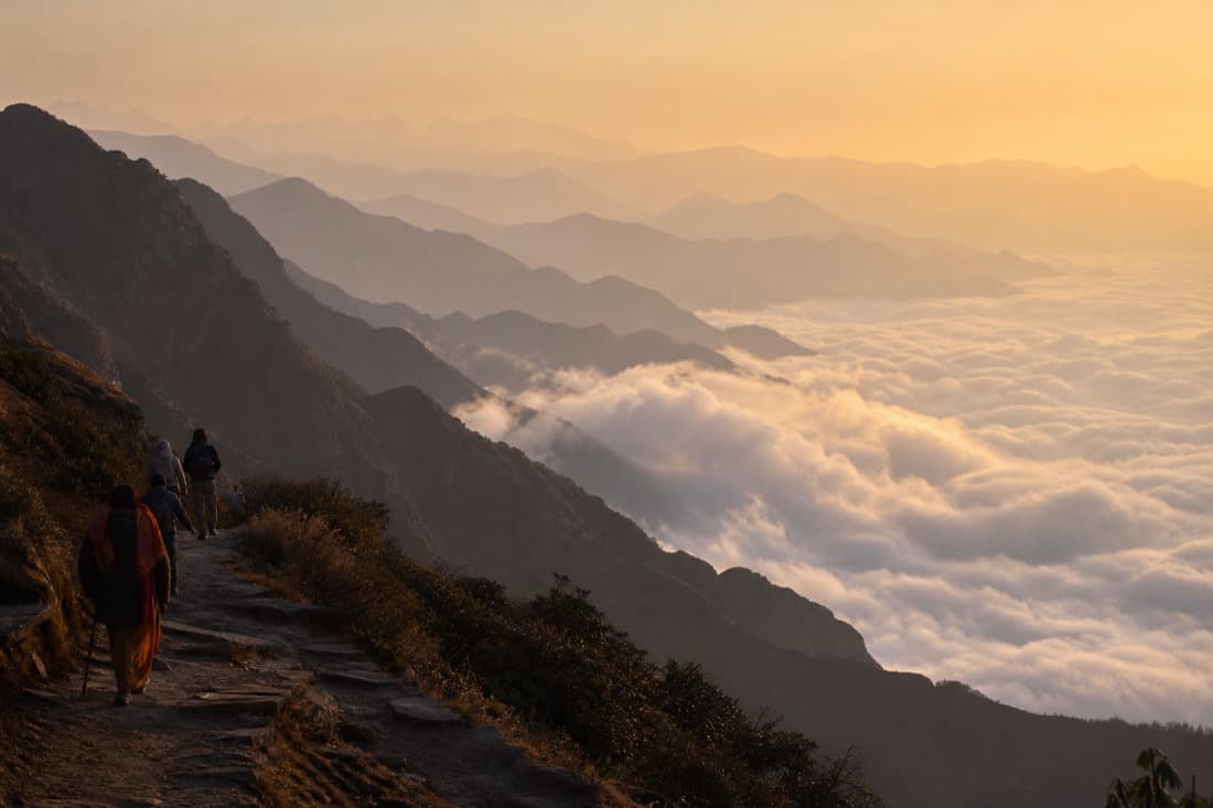 A sea of cloud breaking over a ridgeline