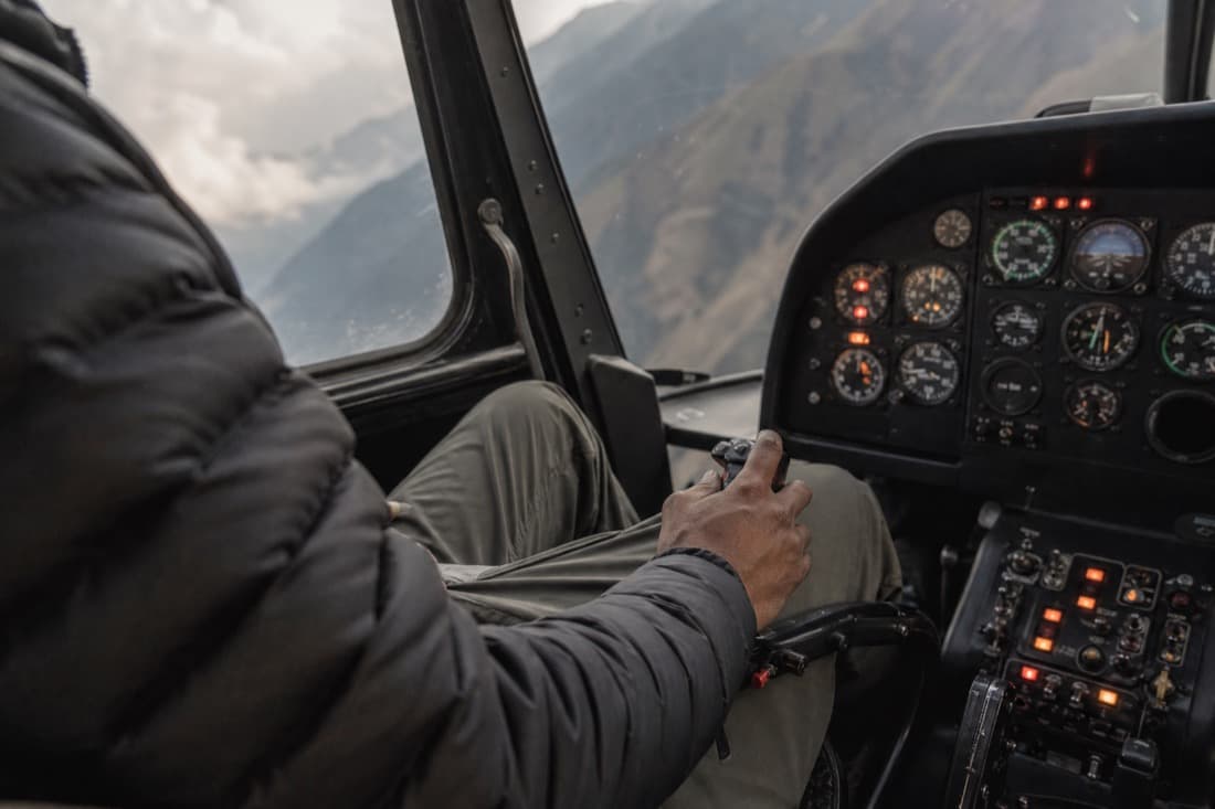 A pilot's hands on the helicopter controls